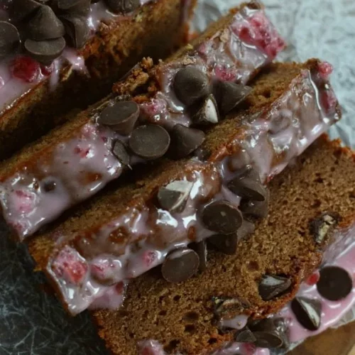 A cut up loaf of Chocolate Cherry Bread