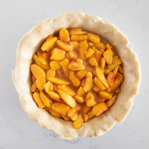 fresh peach pie filling in pie crust
