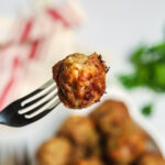 A fork with a meatball on it.
