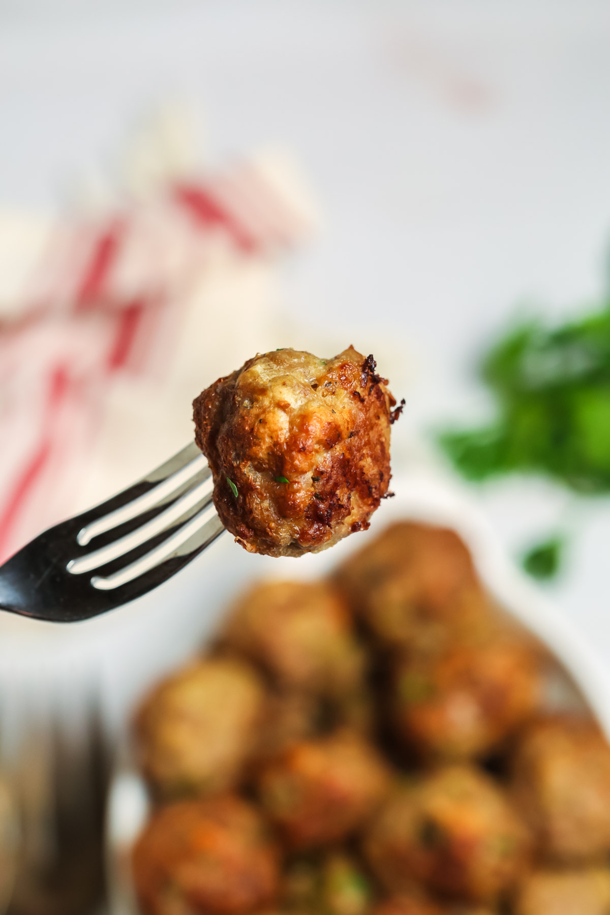 A fork with a meatball on it.