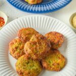 Air Fryer Zucchini Fritters on a paper plate.