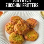A white plate with six golden-brown Air Fryer Zucchini Fritters rests on a light surface, featuring a text overlay that reads "Best Air Fryer Zucchini Fritters.