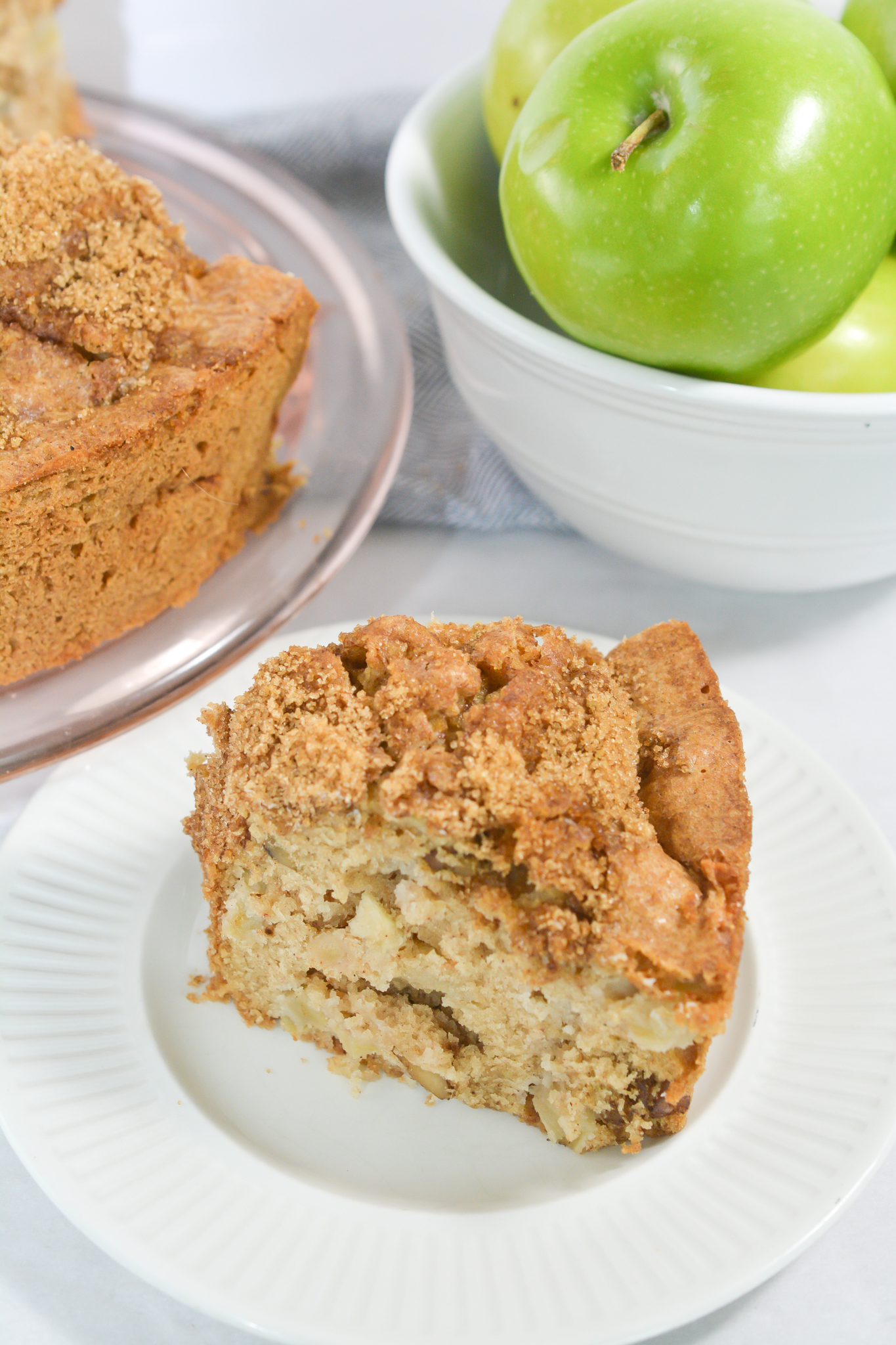 Apple Tea Cake with a bowl of green apples in the background