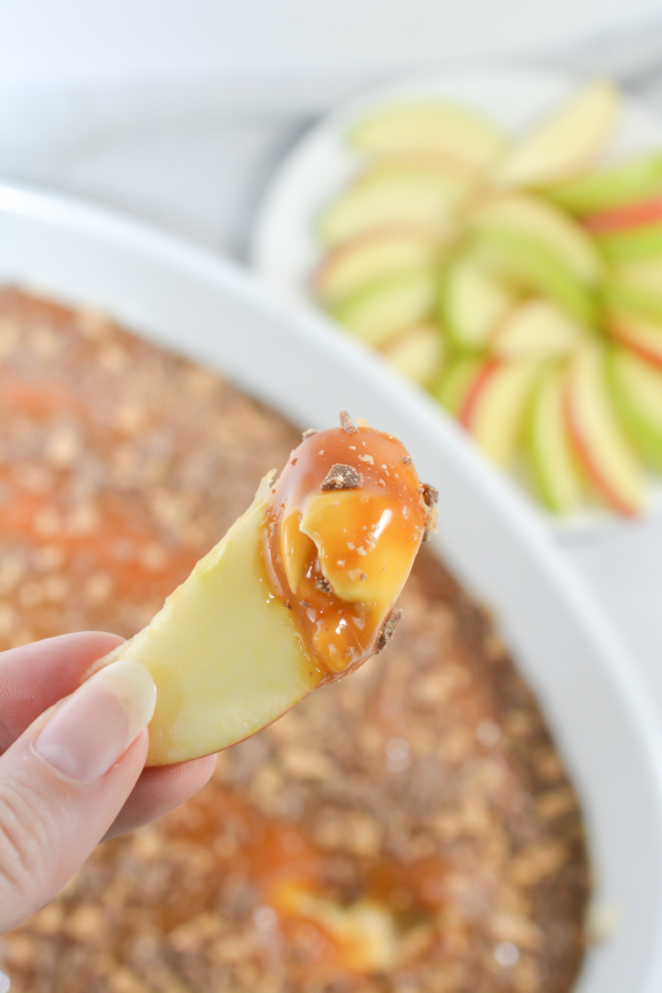 A slice of apple with the dip on it.
