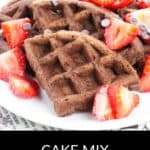 A plate of Chocolate Waffles topped with sliced strawberries and chocolate chips, with “Cake Mix Chocolate Waffles” written below.