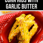 Corn Ribs with Garlic Butter served in a red dish on a white surface with a red polka dot cloth.