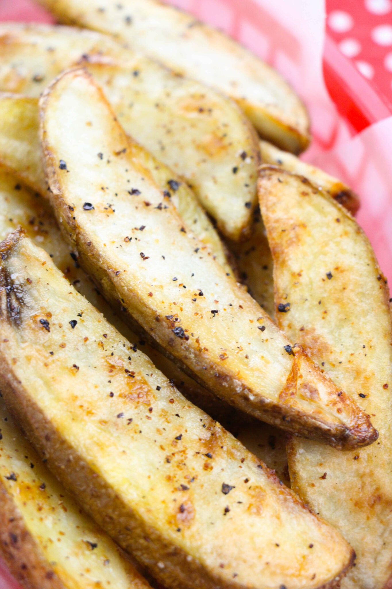 A basket of Crispy Spiced Potato Wedges.