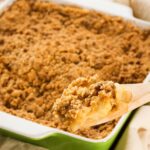 Easy Apple Crumble in a green casserole pan.