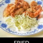 A plate of crispy Panko Shrimp and shredded cabbage is served on a blue and white floral dish.