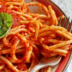 Hearty Marinara sauce over spaghetti on a plate.