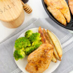 A tiop shot of the chicken with a side of broccoli and potato wedges.