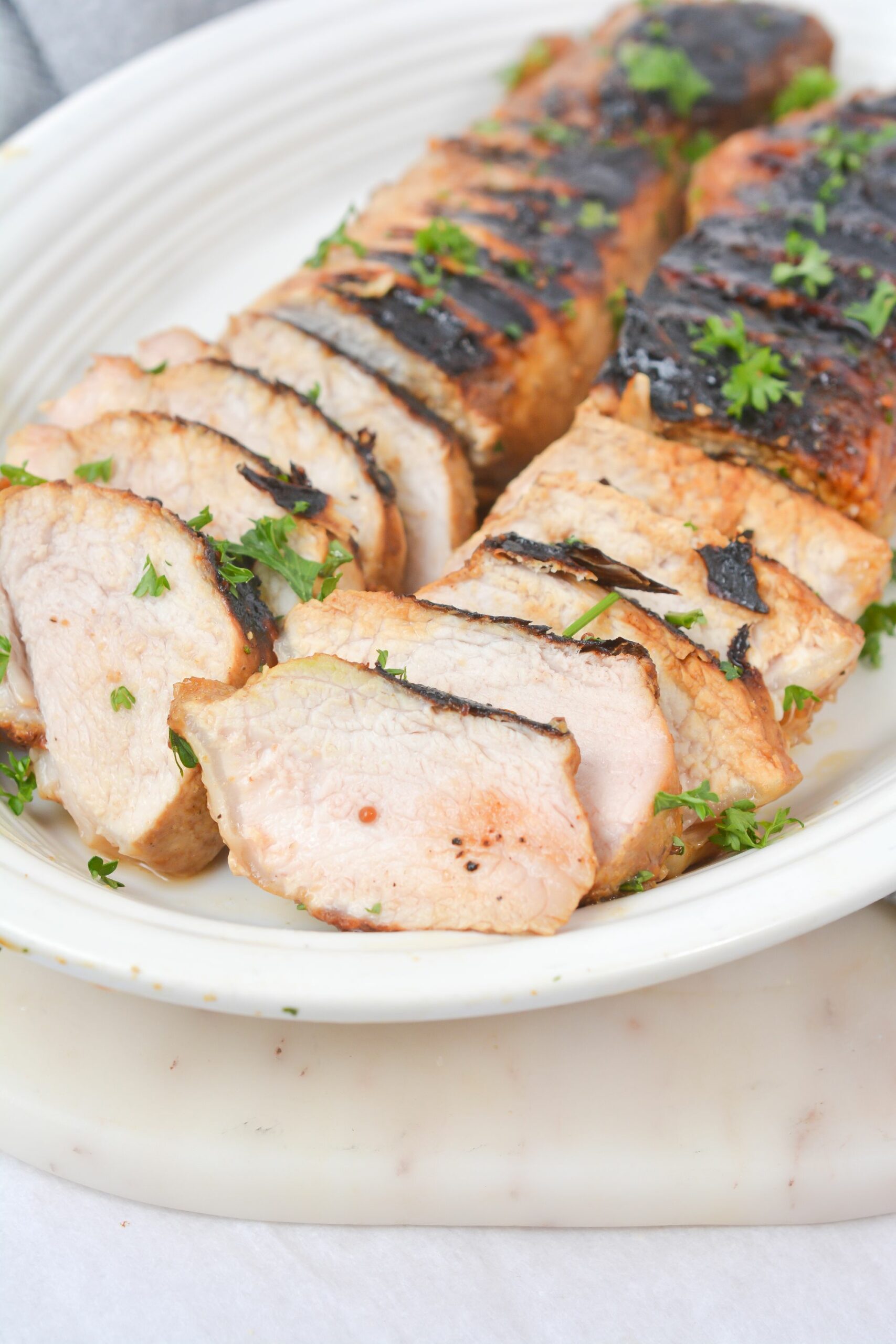 Marinated Grilled Pork Loin on a white plate.