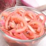 A glass bowl filled with vegetables in vinegar.