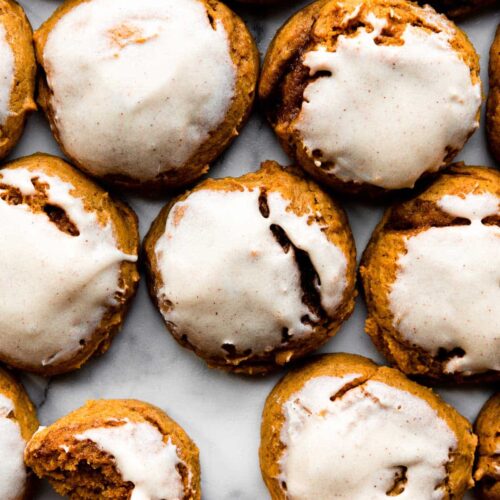 Soft Pumpkin cookies with icing on tray