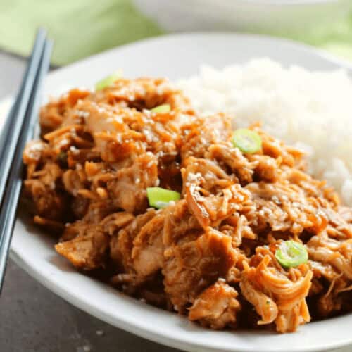 Crock pot Teriyaki chicken thighs with rice and chopsticks.