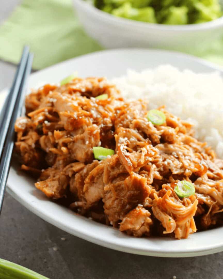 Crock pot Teriyaki chicken thighs with rice and chopsticks.