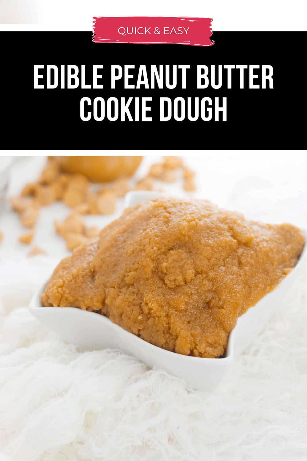 A white square dish cradles luscious edible peanut butter cookie dough, its enticing aroma wafting through the air as golden crumbs scatter like sweet confetti on the plush white surface.