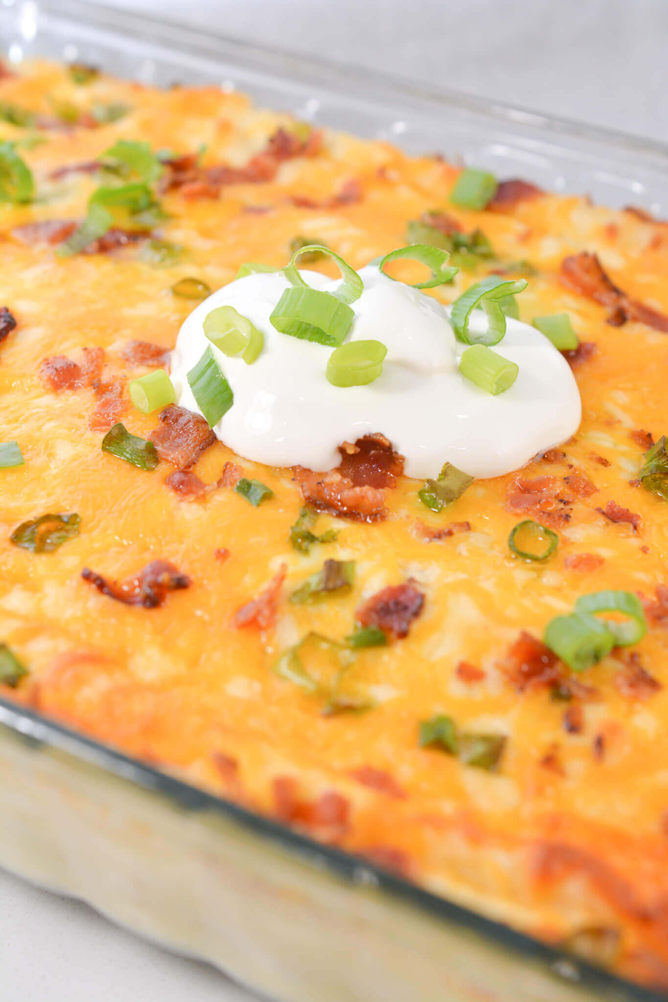 A casserole with sour cream on top.