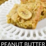 A Peanut Butter Banana Bar, topped with a crunchy banana chip, is elegantly served on a white decorative plate—perfect for fans of Peanut Butter Banana Bars.