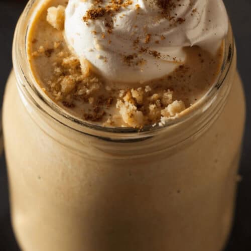 A top shot of the pumpkin milkshake with whip cream on top.