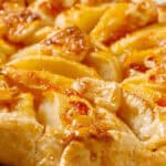 A side view of a rustic apple tart.