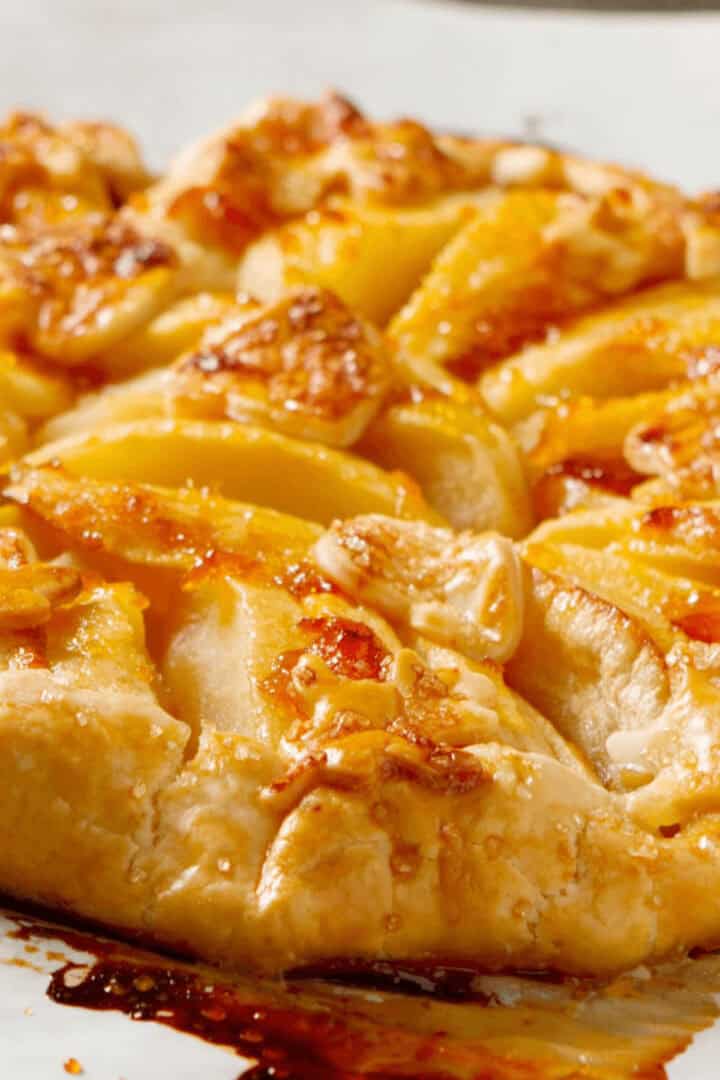 A side view of a rustic apple tart.