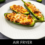 Three delicious air fryer jalapeno poppers with melted cheese sit enticingly on a white plate, ready to be savored.