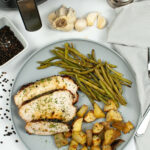 A plate with the turkey breast green beans and potatoes.