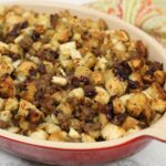 apple and sausage stuffing in a casserole dish.