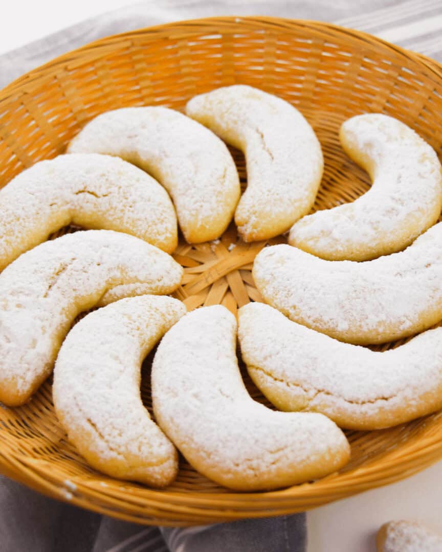 A close up on the almond flavored crescent cookies.