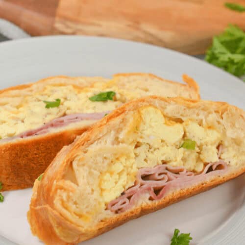 A white plate with the breakfast stuffed bread.