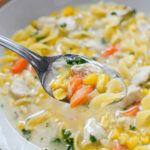 Serving up a dish of the chicken corn noodle soup.