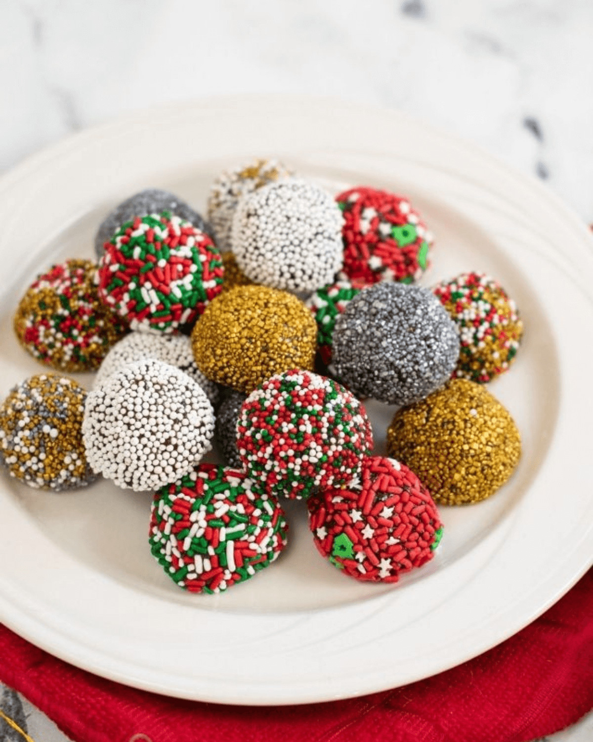 Christmas Brownie Balls staked on a plate.
