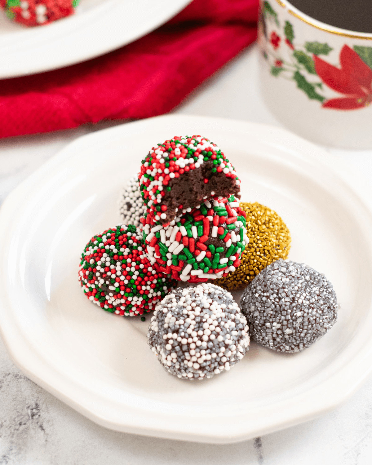 Five of the brownie balls with colorful sprinkles.