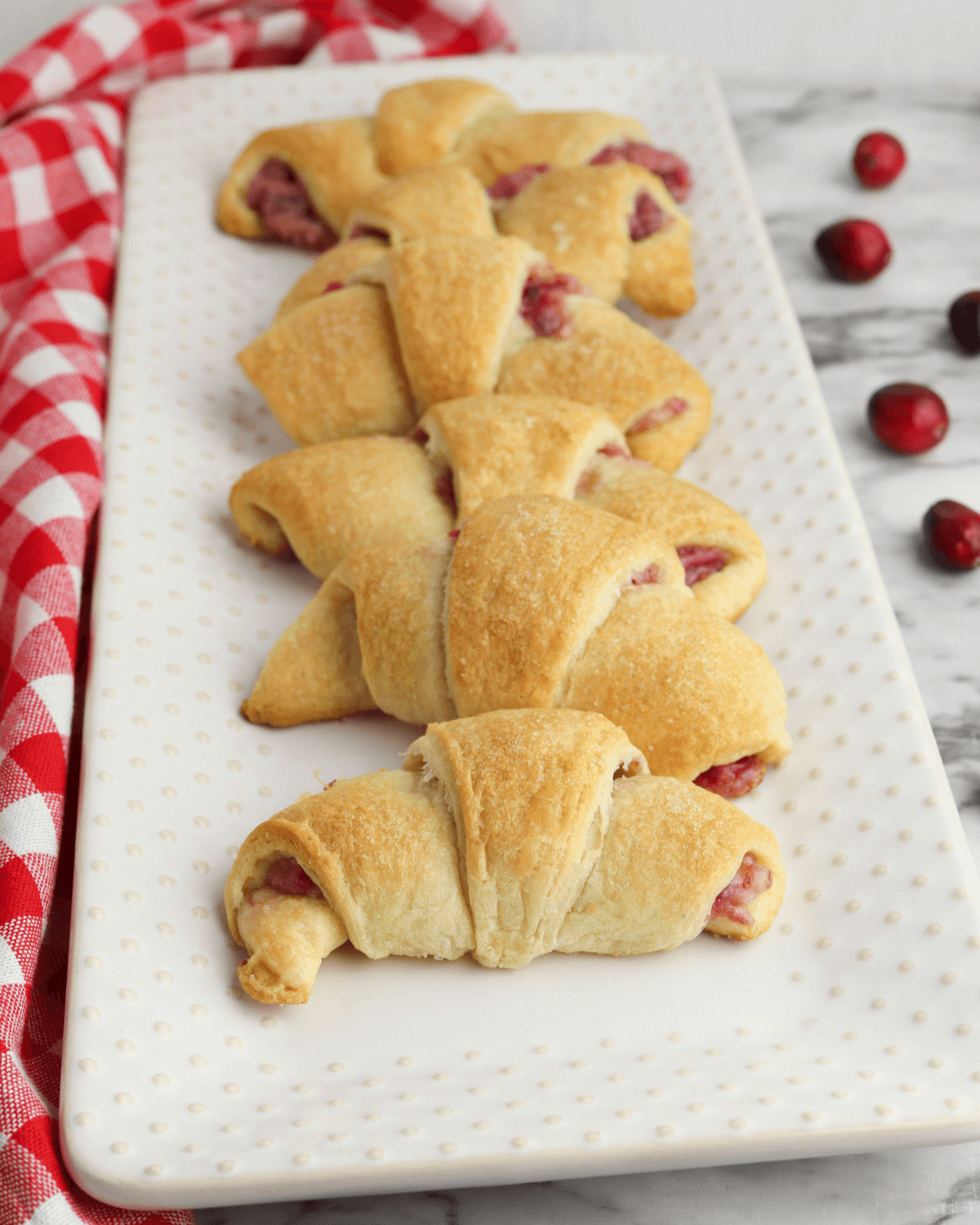 A serving platter filled with the cranberry cheesecake crescent rolls.