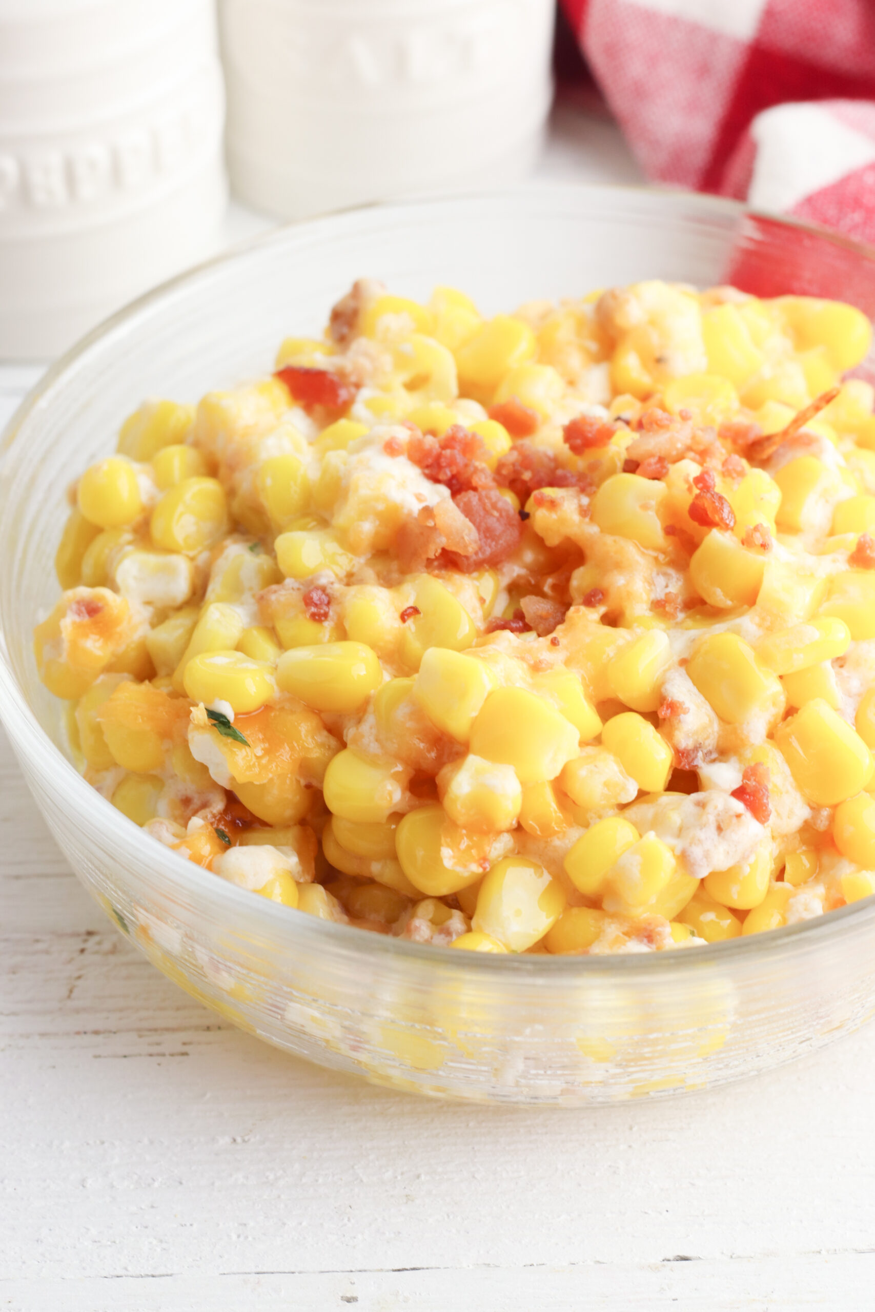A bowl of the cream cheese corn casserole with bacon.