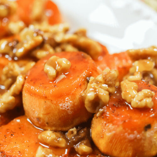 A Maple sweet potato dish with nuts on top.