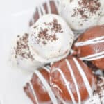 A stack of oreo cookie balls on a platter.