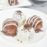 Four white and dark chocolate treats.