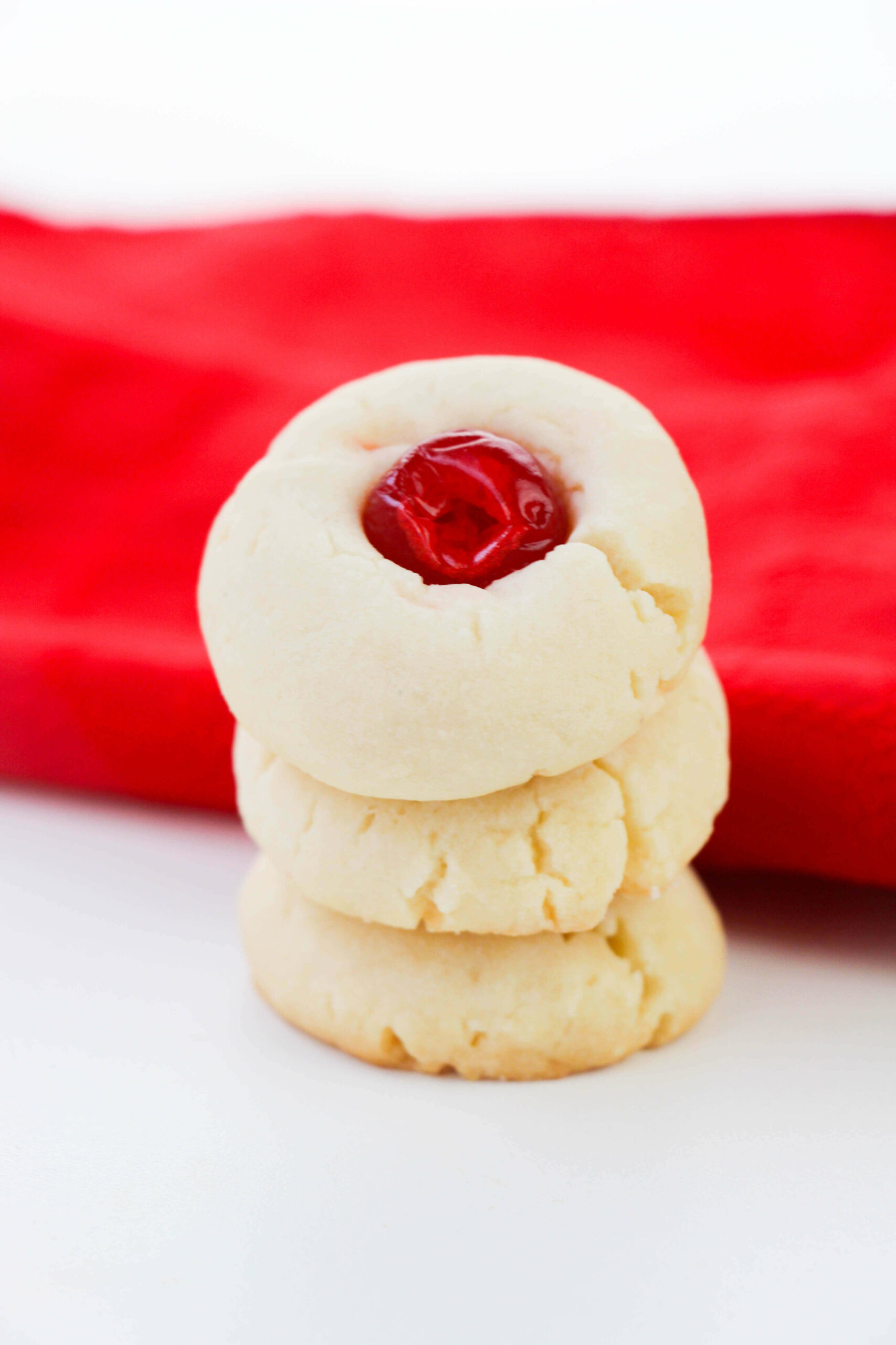 A stack of shortbread with cherries.