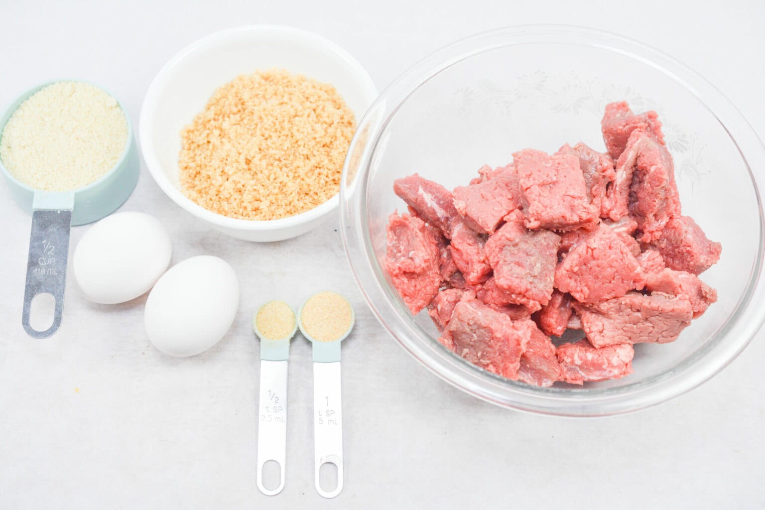 Pieces of steak and eggs, bread crumbs etc.