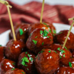 A stack of barbeque sauce and grape jelly meatballs.
