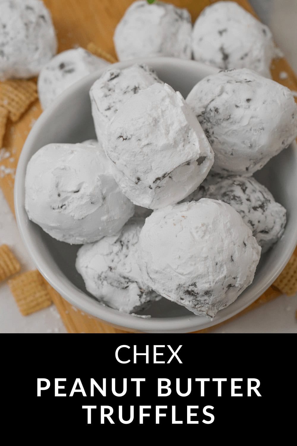 A bowl of powdered sugar-coated peanut butter truffles sits elegantly on a wooden surface, with a few scattered cereal pieces adding a rustic touch.
