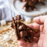 A hand holding the Chocolate Peanut Butter Haystacks.