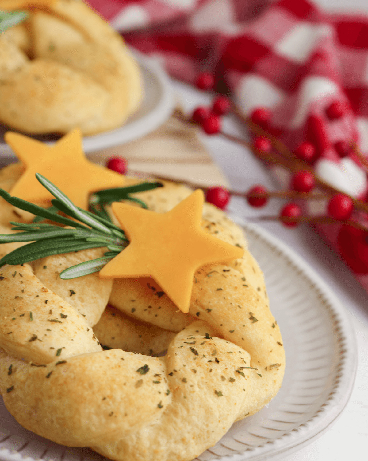 The Christmas Wreath Appetizer with a sprig of rosemary and cheese stars.