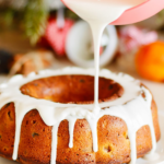 Drizzling the icing on top of the cinnamon bundt cake.
