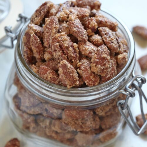 A glass jar of the cinnamon roasted pecans.