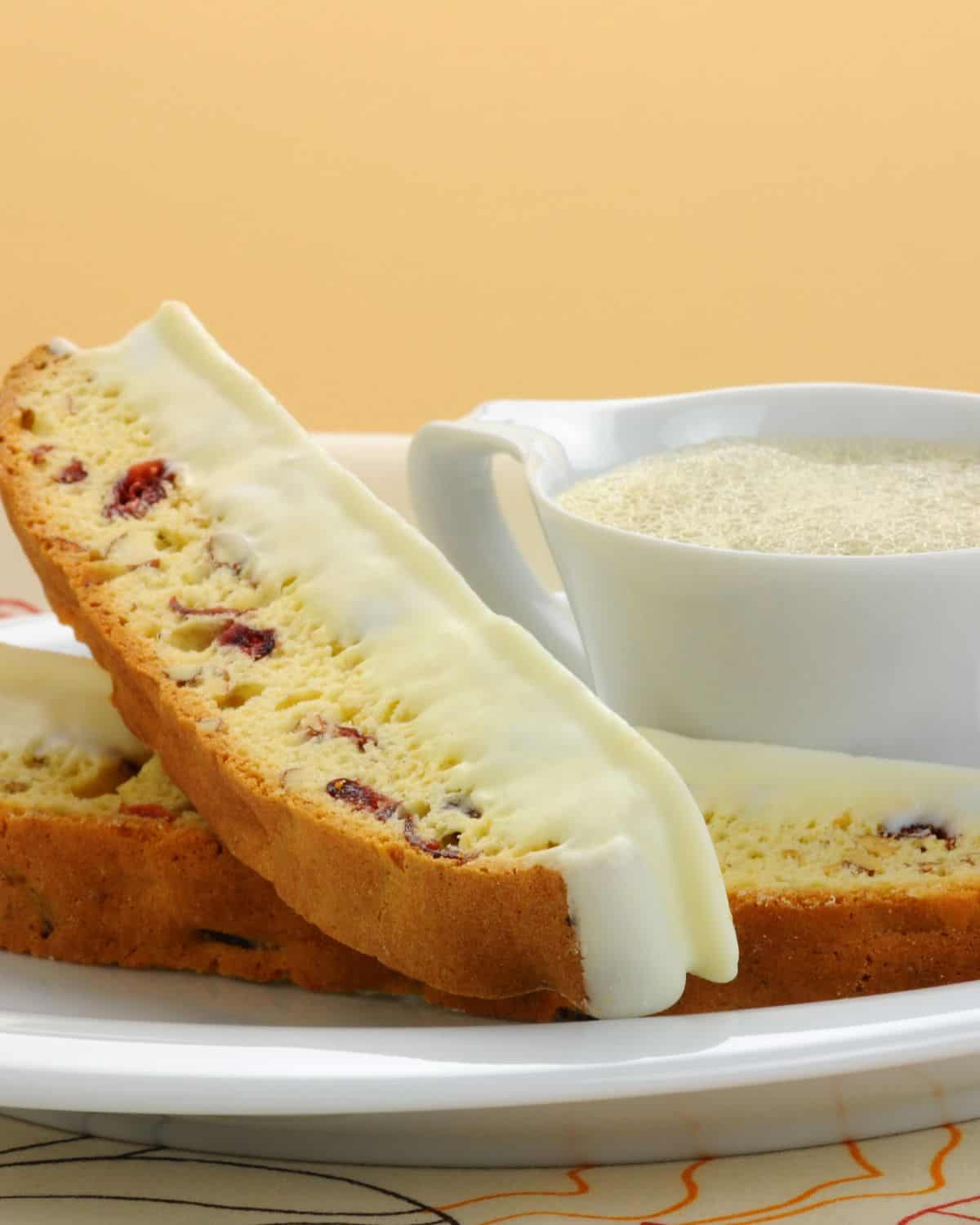 A plate of the cranberry orange biscotti with a side of dipping sauce.