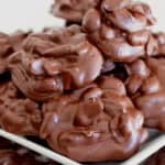 A white plate of the crockpot peanut clusters.