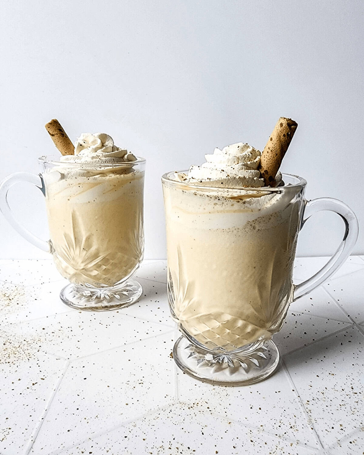 Two side by side eggnog milkshakes.
